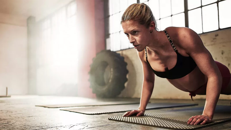Woman performing push up as part of Tabata workout