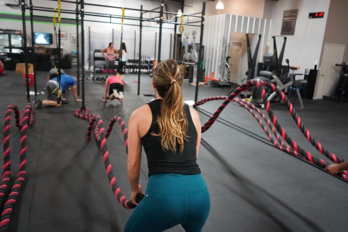 woman doing rope slams as a hiit exercise