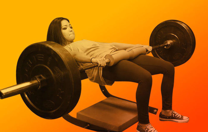 female athlete at top of hip thrust exercise