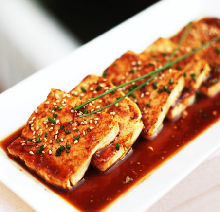 tofu served in an asian dish with soy sauce as a high protein source