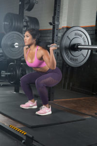 woman performs back squat for Boss workouts