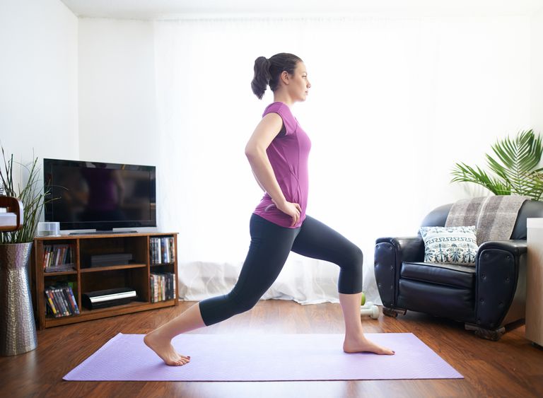 Woman taking part in beginner strength training workout at home